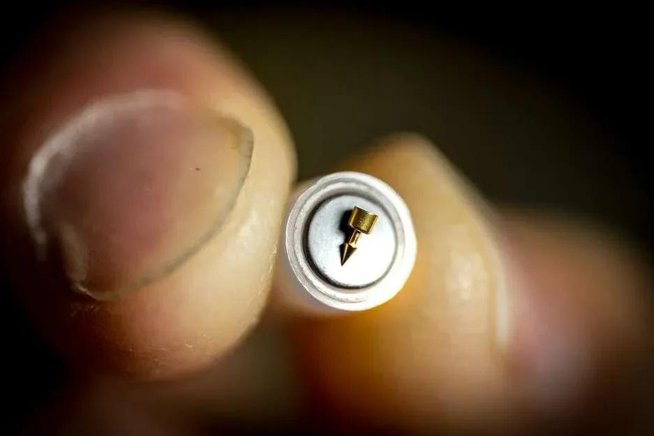 battlefield acupuncture needle held pinched by hand