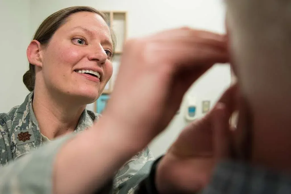 lady smiling and applying bfa needles to patient