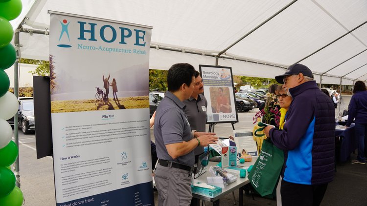 HOPE Clinic staff presenting services to visitors at stroke awareness information booth
