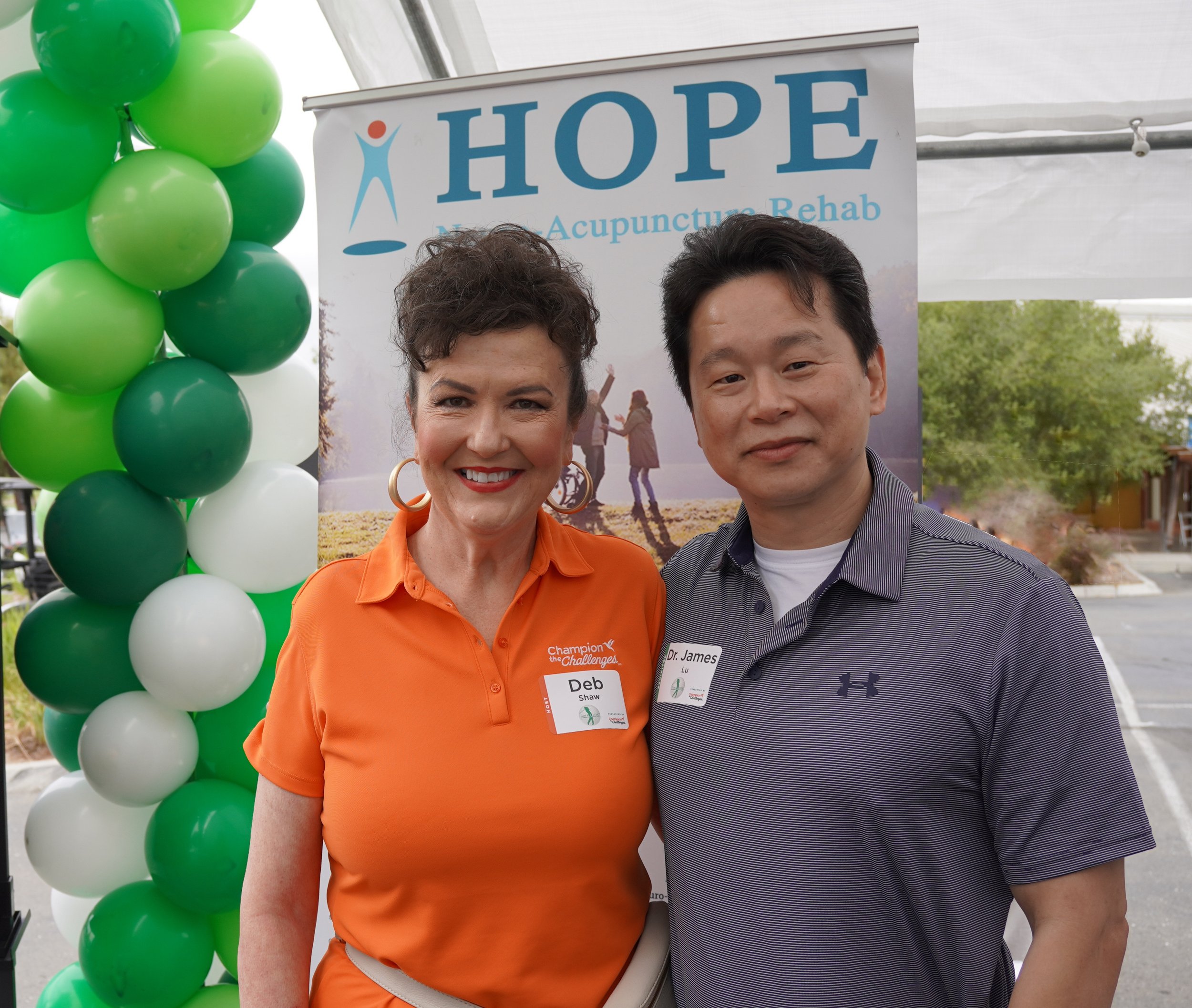 Deb from Champion the Challenges posing with Dr. Lu at HOPE Clinic community event