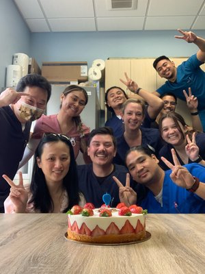 HOPE Clinic team celebrating with strawberry cake in break room