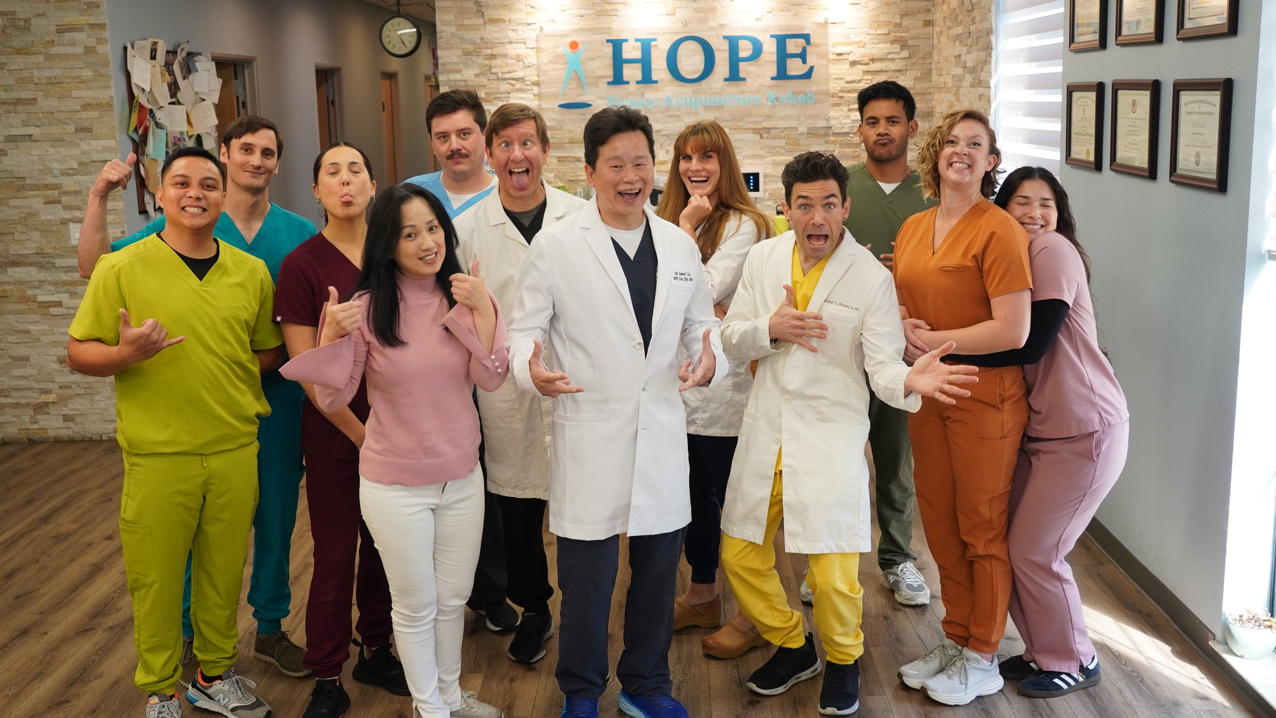 HOPE Clinic team fun group photo with playful poses and expressions in lobby