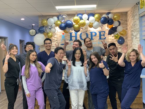 HOPE Clinic team celebrating with balloon arch in lobby