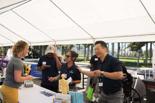 Dr. Lu and staff interacting with visitors at community stroke awareness booth